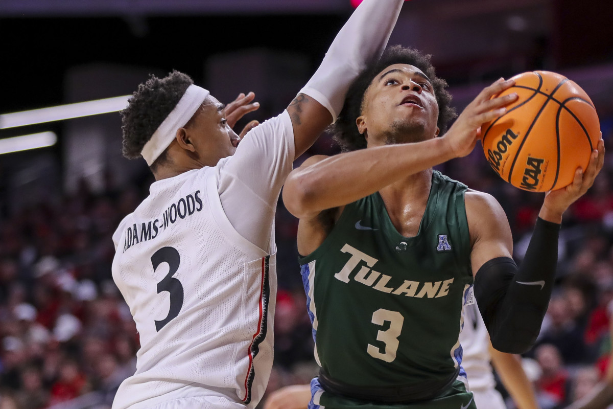 Dec 29, 2022; Cincinnati, Ohio, USA; Tulane Green Wave guard Jalen Cook (3) drives to the basket against Cincinnati Bearcats guard Mika Adams-Woods (3) in the second half at Fifth Third Arena. Mandatory Credit: Katie Stratman-USA TODAY Sports
